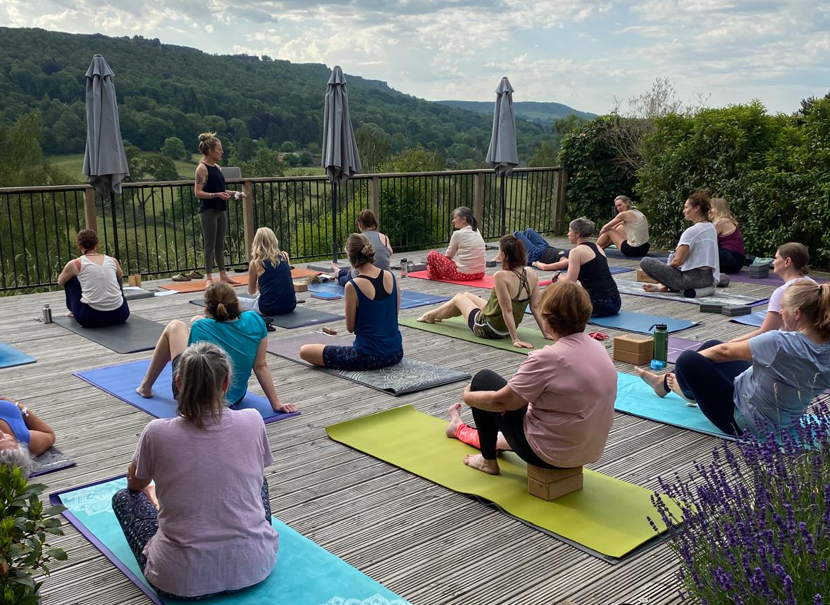 Sarah leading a yoga class at a CottonYoga retreat